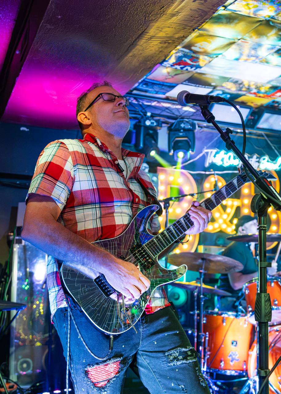 Bobby Leavens performing live with dark Ibanez guitar